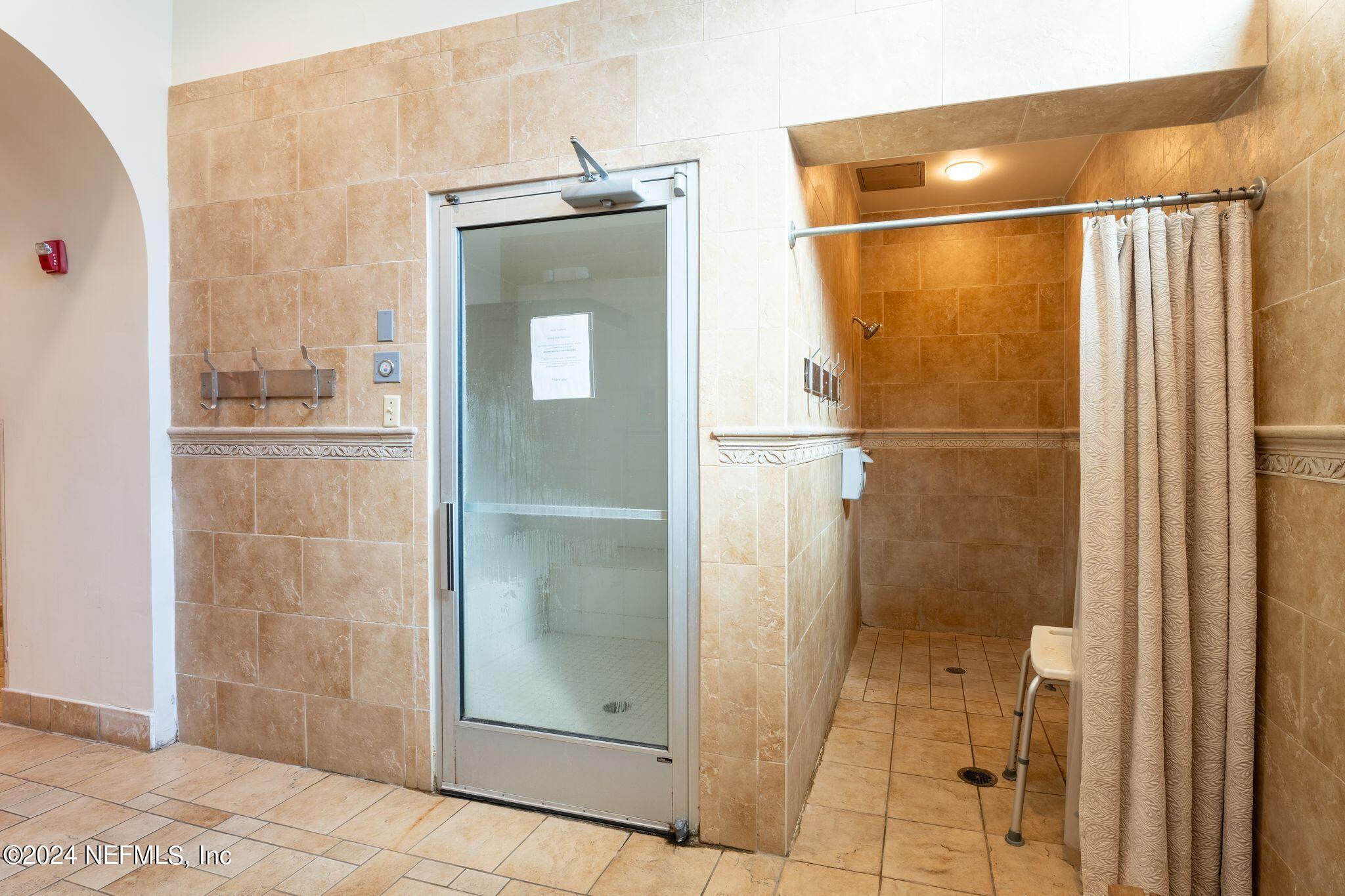 206 Medio Drive St. Augustine, FL 32095 - Photo 57 of 57 a bathroom with a shower and a mirror