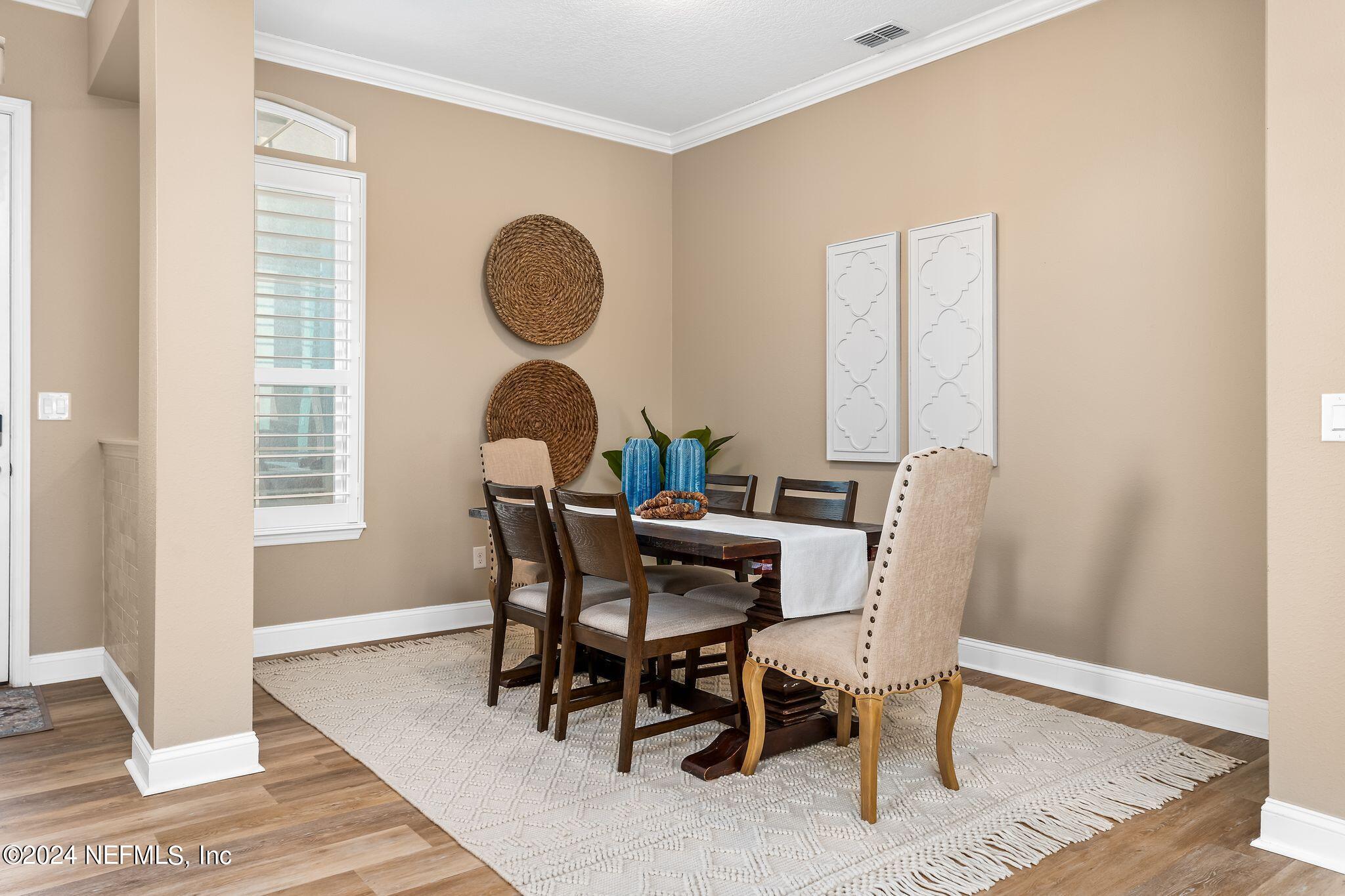 206 Medio Drive St. Augustine, FL 32095 - Photo 7 of 57 a view of a dining room with furniture and wooden floor