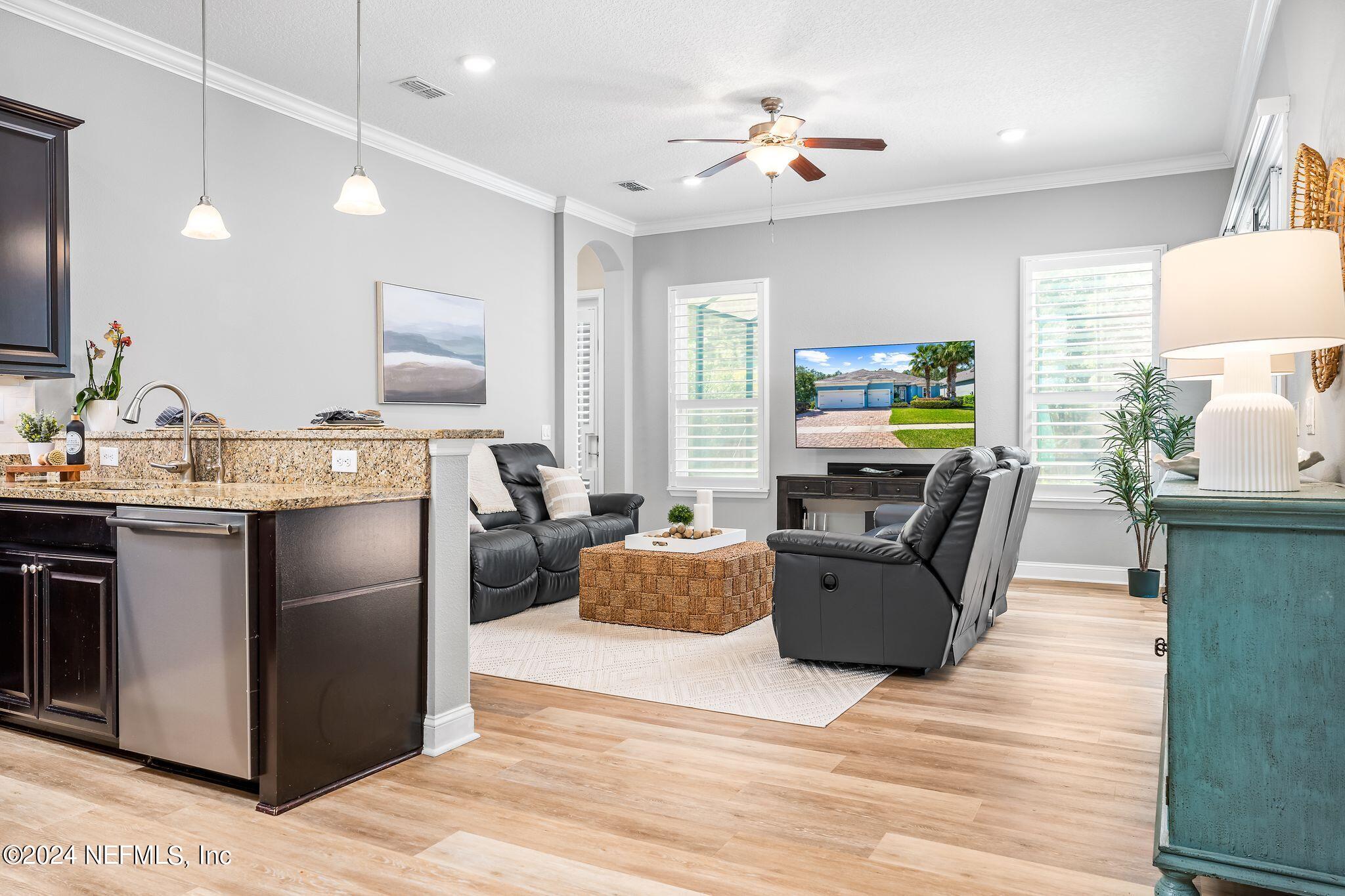 206 Medio Drive St. Augustine, FL 32095 - Photo 8 of 57 a kitchen with stainless steel appliances granite countertop a stove refrigerator and a view of living room