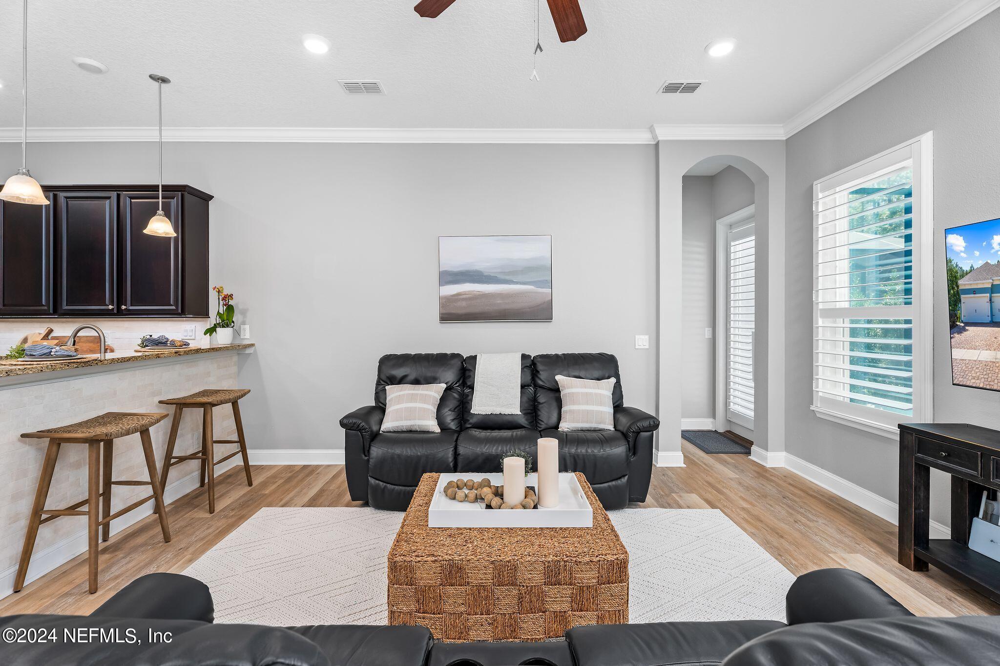 206 Medio Drive St. Augustine, FL 32095 - Photo 9 of 57 a living room with furniture and a flat screen tv