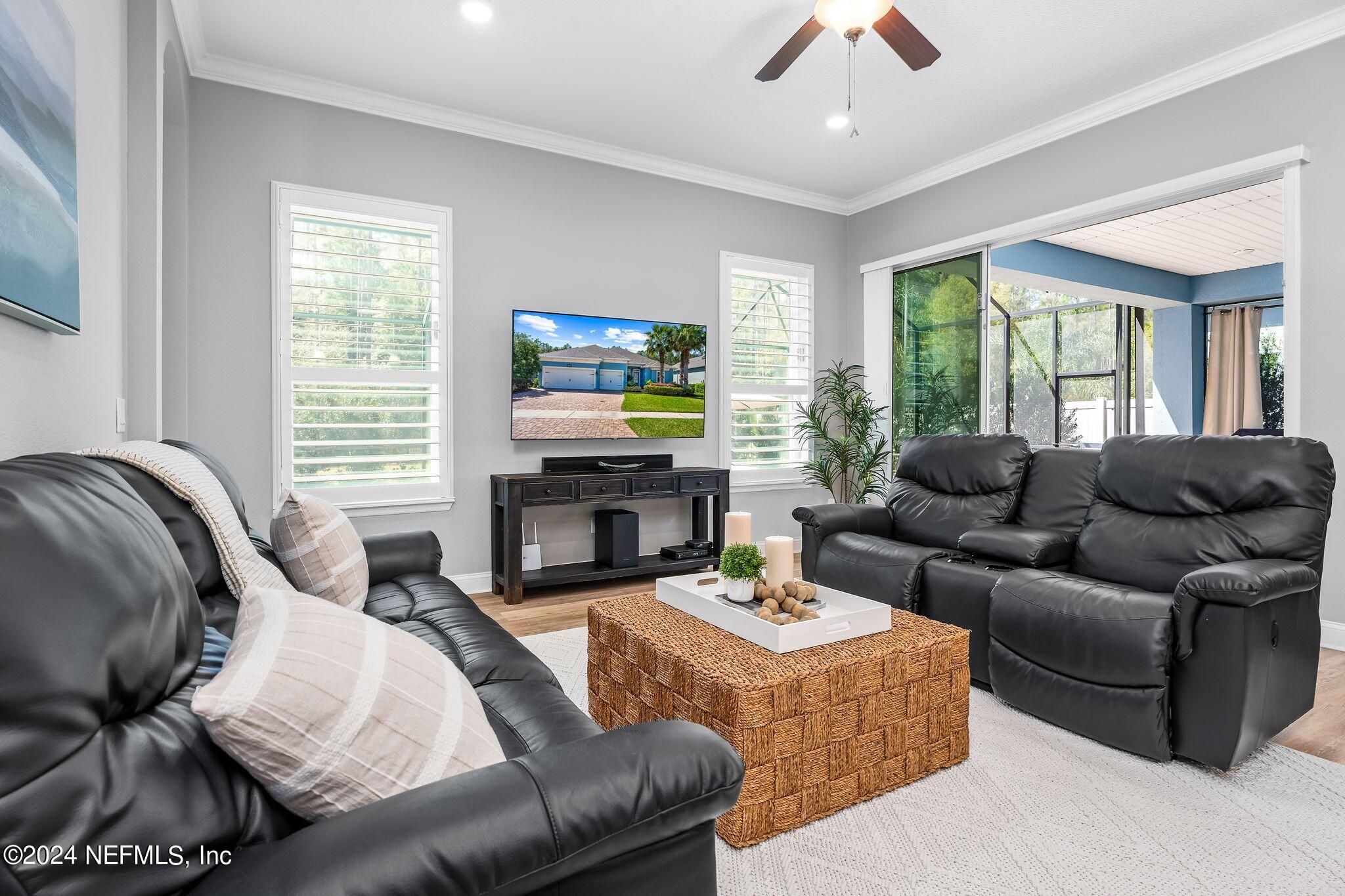 206 Medio Drive St. Augustine, FL 32095 - Photo 10 of 57 a living room with fireplace furniture and a flat screen tv