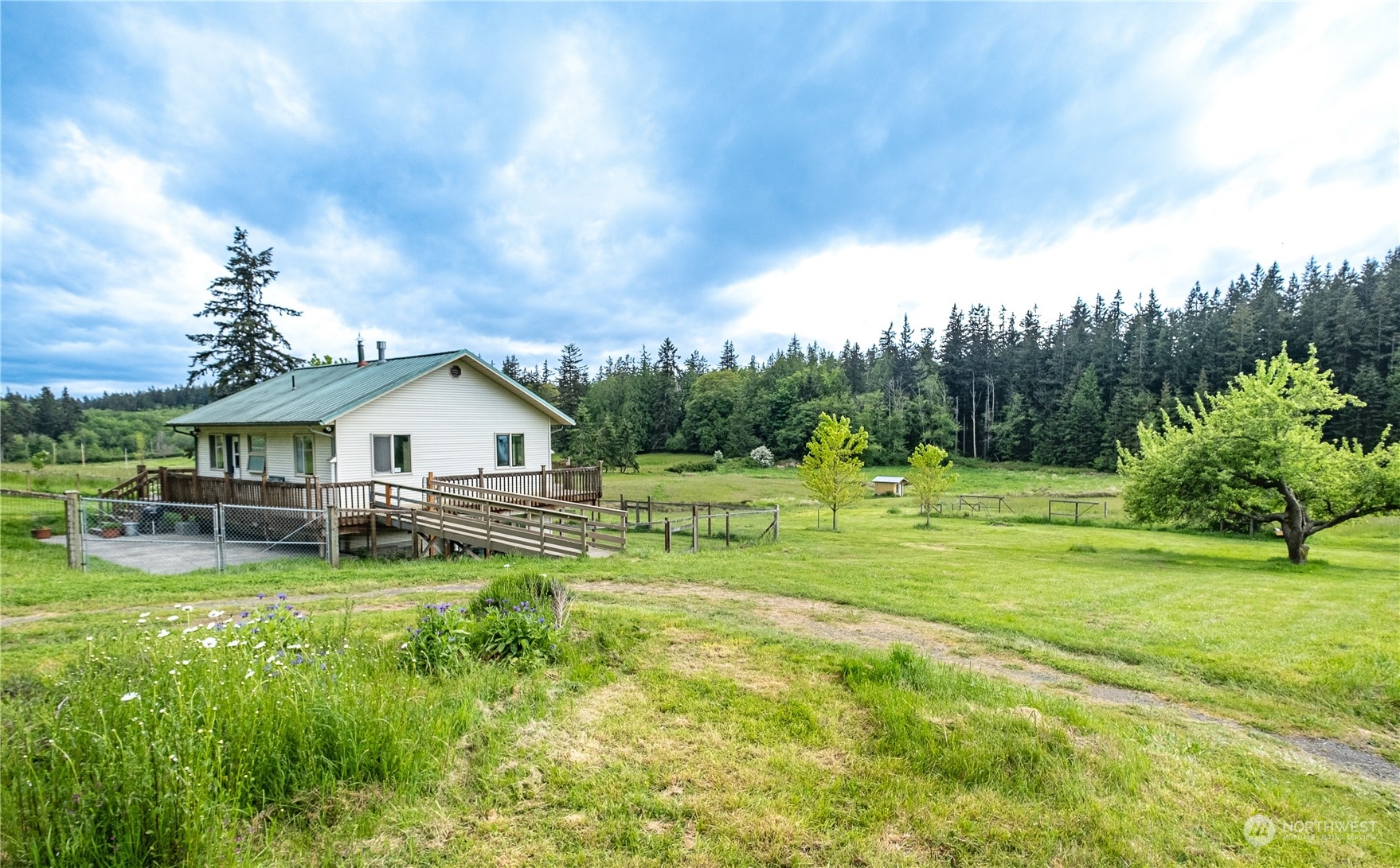 1750 Lancaster Road Freeland, WA 98249 - Photo 2 of 33 a view of a house with a big yard and sitting area