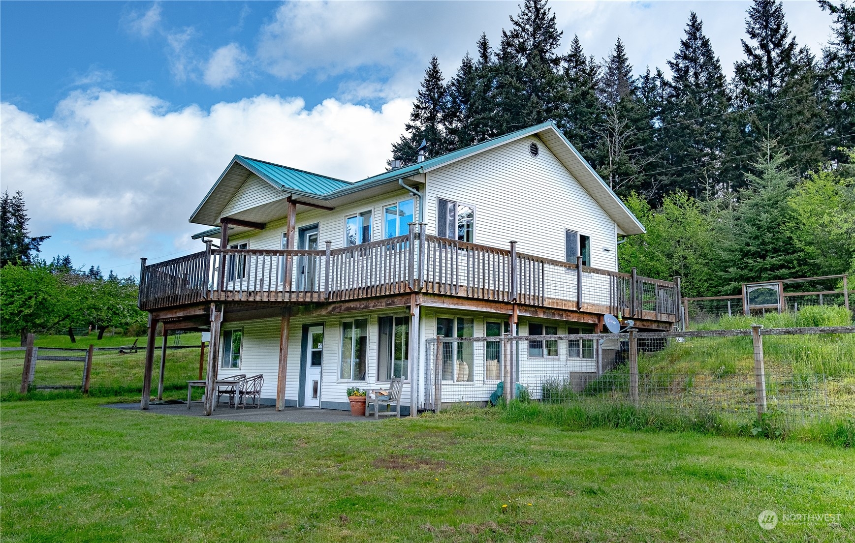 1750 Lancaster Road Freeland, WA 98249 - Photo 5 of 33 a view of white house with a big yard and large trees