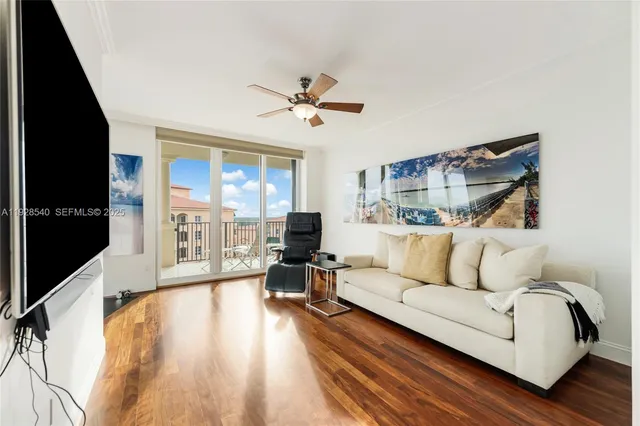 a living room with furniture and large windows