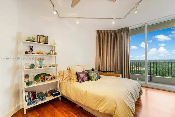 a bedroom with a large bed and a chandelier