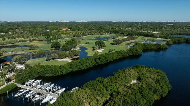 an aerial view of residential building with outdoor space and lake view in back