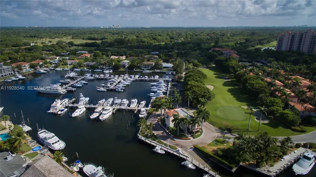 an aerial view of lake and residential houses with outdoor space