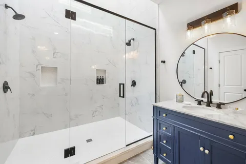a bathroom with a tub sink and mirror