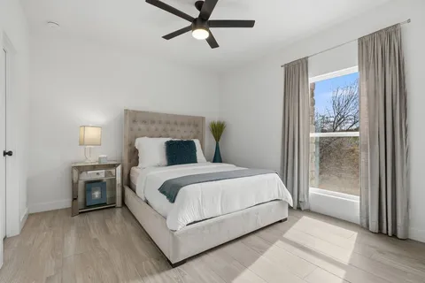 a bed sitting in a bedroom next to a window