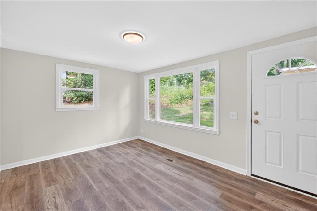136 Nowell Street Monroe, GA 30655 - Photo 9 of 25 a view of room with window and hardwood floor