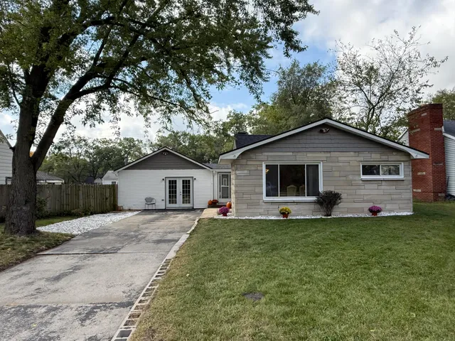 a front view of house with yard and trees