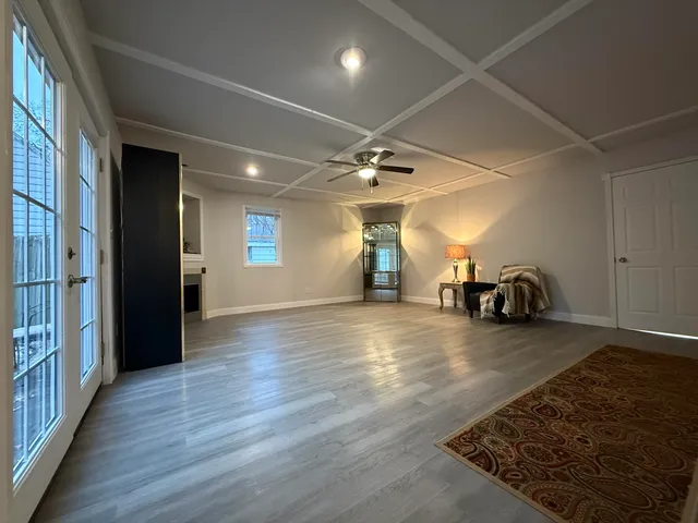 a view of a room with wooden floor