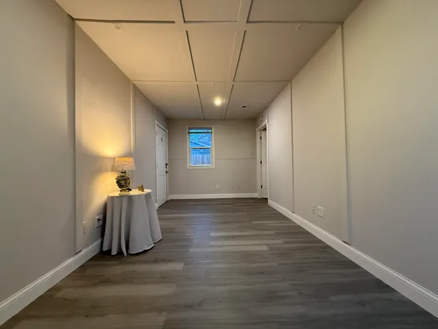 a view of a livingroom with wooden floor and a window
