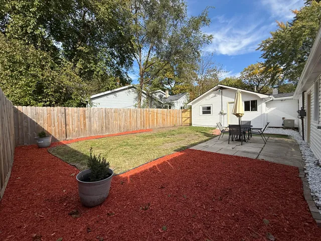 a view of a backyard with plants and patio