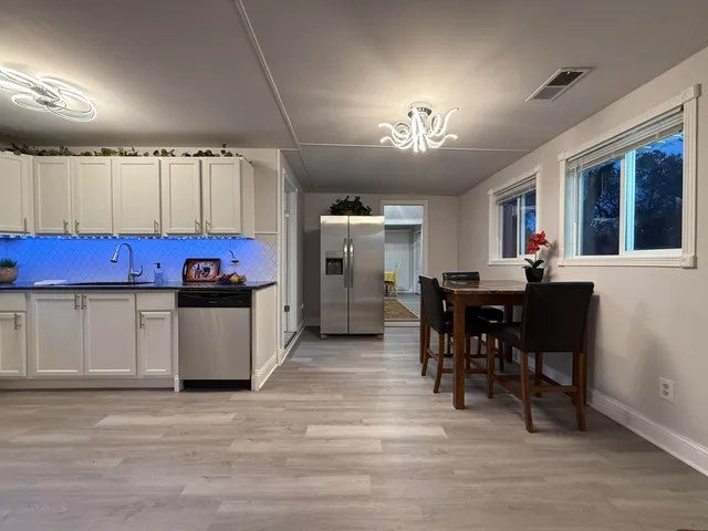 a view of a dining room with furniture and chandelier