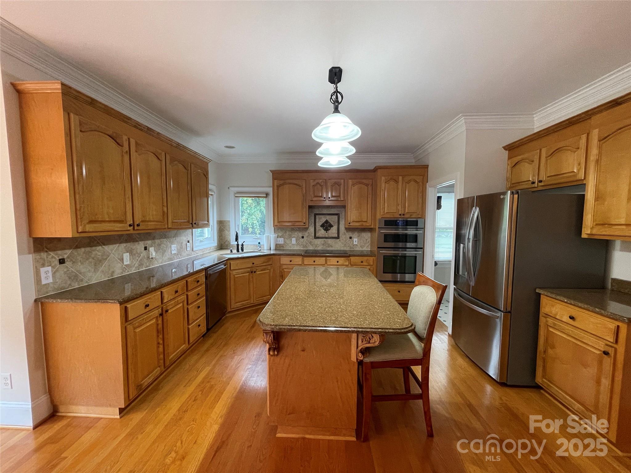103 Berea Baptist Church Road Stanfield, NC 28163 - Photo 14 of 46 a kitchen with stainless steel appliances granite countertop a refrigerator a sink dishwasher a stove with wooden cabinets and floor