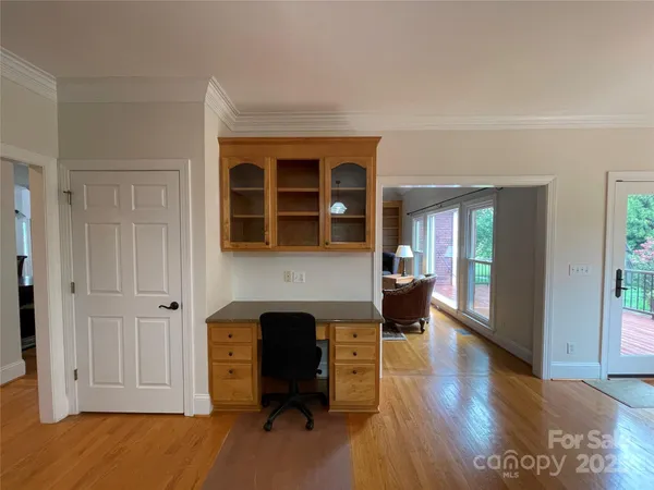 a view of an empty room with glass door and windows