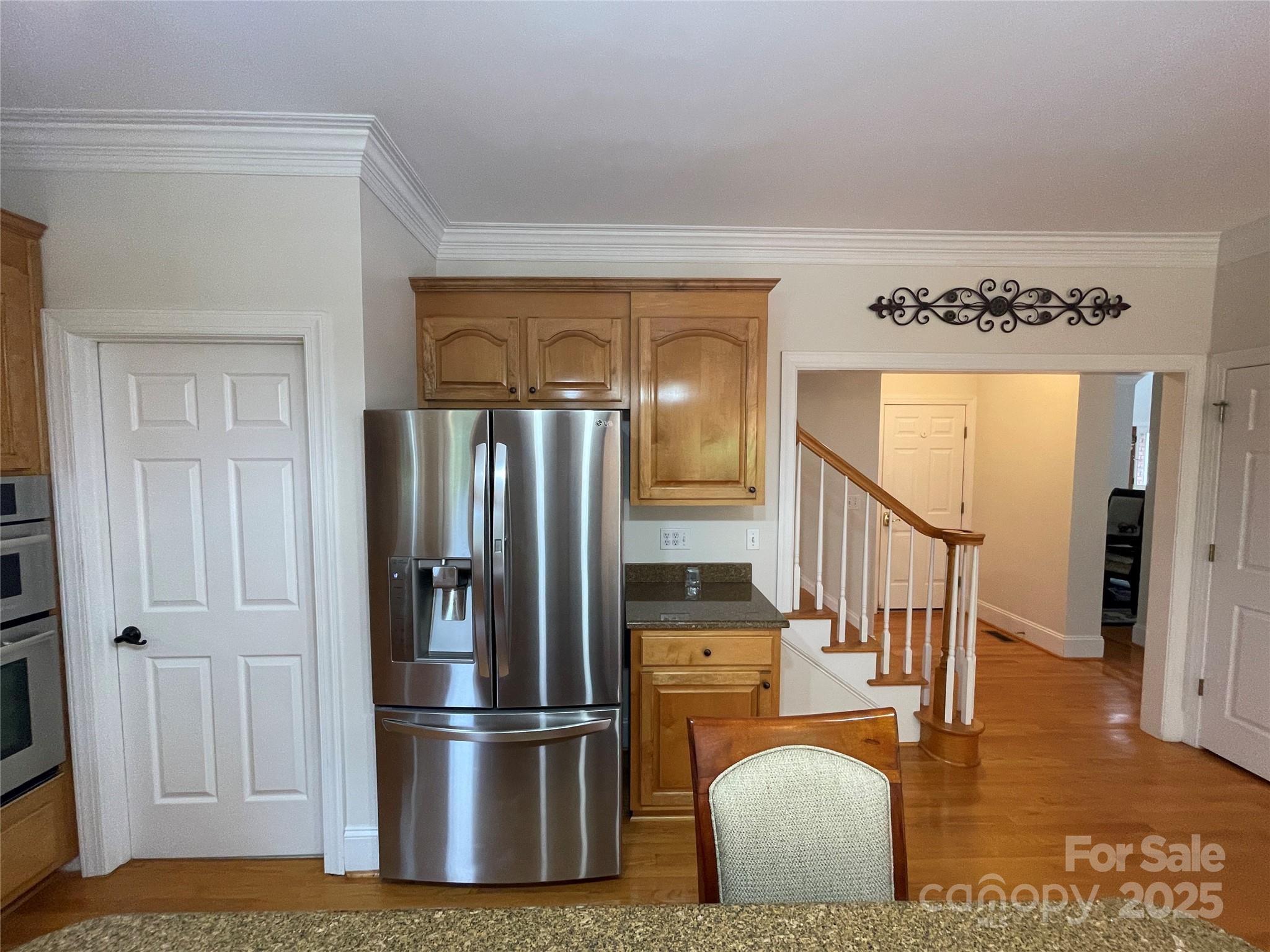 103 Berea Baptist Church Road Stanfield, NC 28163 - Photo 18 of 46 a kitchen with stainless steel appliances granite countertop a refrigerator a stove and a sink with wooden floor