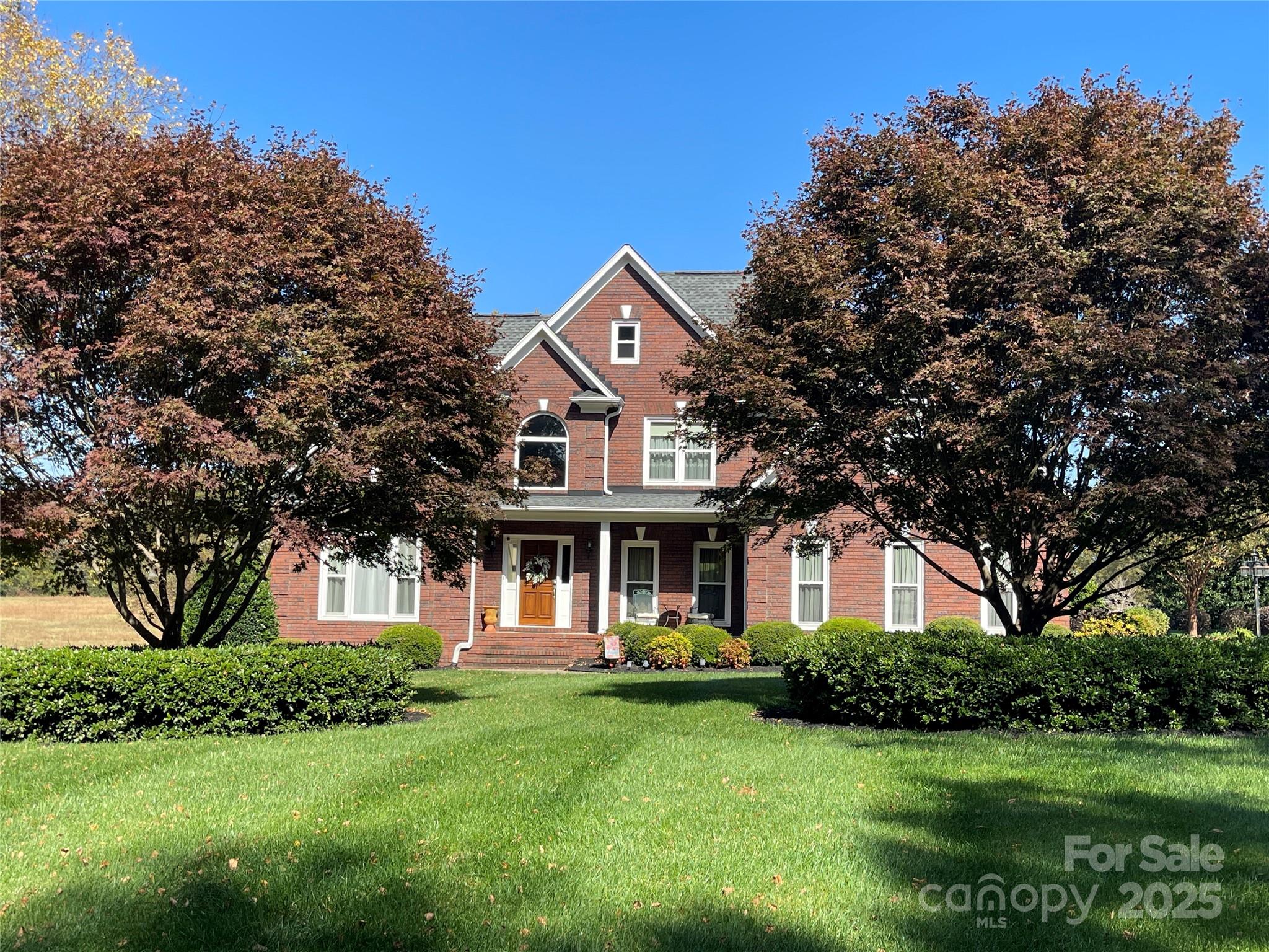 103 Berea Baptist Church Road Stanfield, NC 28163 - Photo 2 of 46 a front view of a house with a garden
