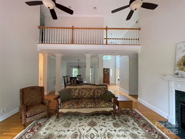 a bedroom with furniture and a large window