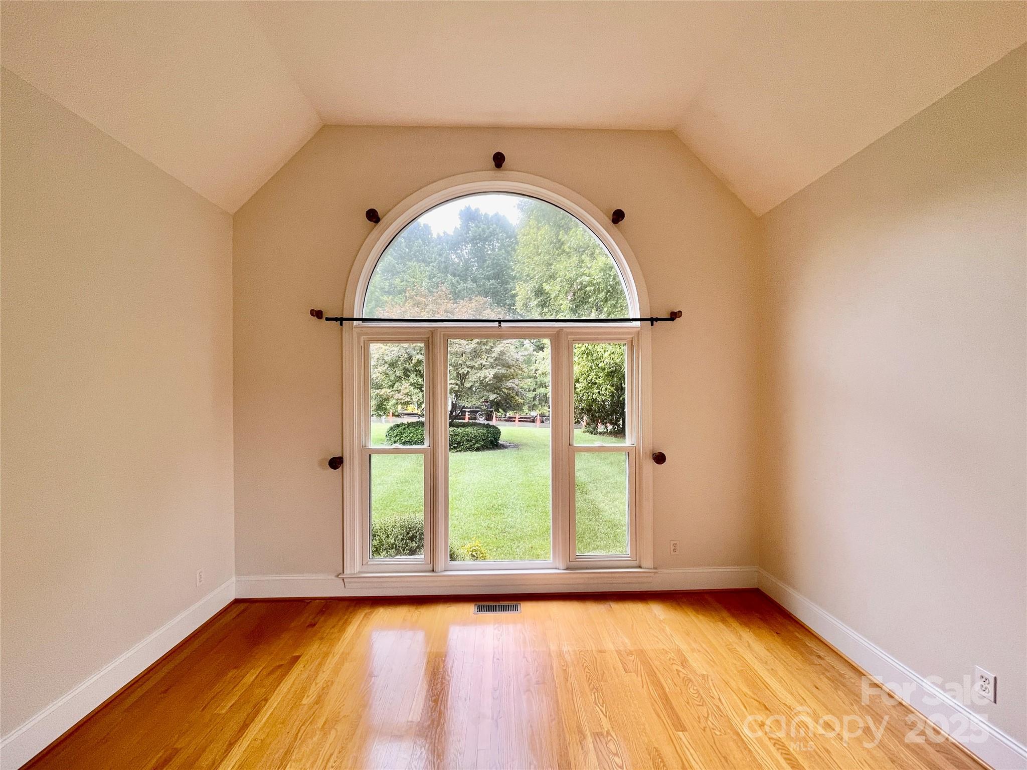 103 Berea Baptist Church Road Stanfield, NC 28163 - Photo 8 of 46 an empty room with wooden floor and windows