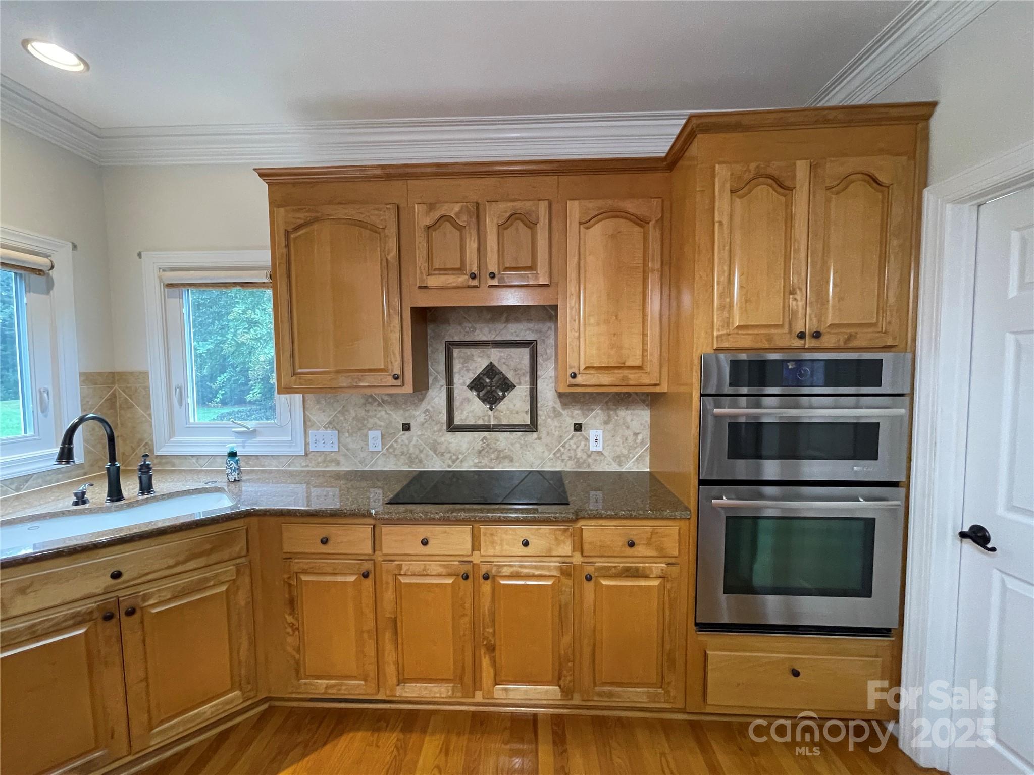 103 Berea Baptist Church Road Stanfield, NC 28163 - Photo 10 of 46 a kitchen with stainless steel appliances granite countertop a sink and cabinets