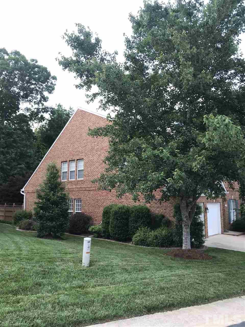 3923 Sunset Maple Court Raleigh, NC 27612 - Photo 2 of 3 a view of a house with a yard and a large tree