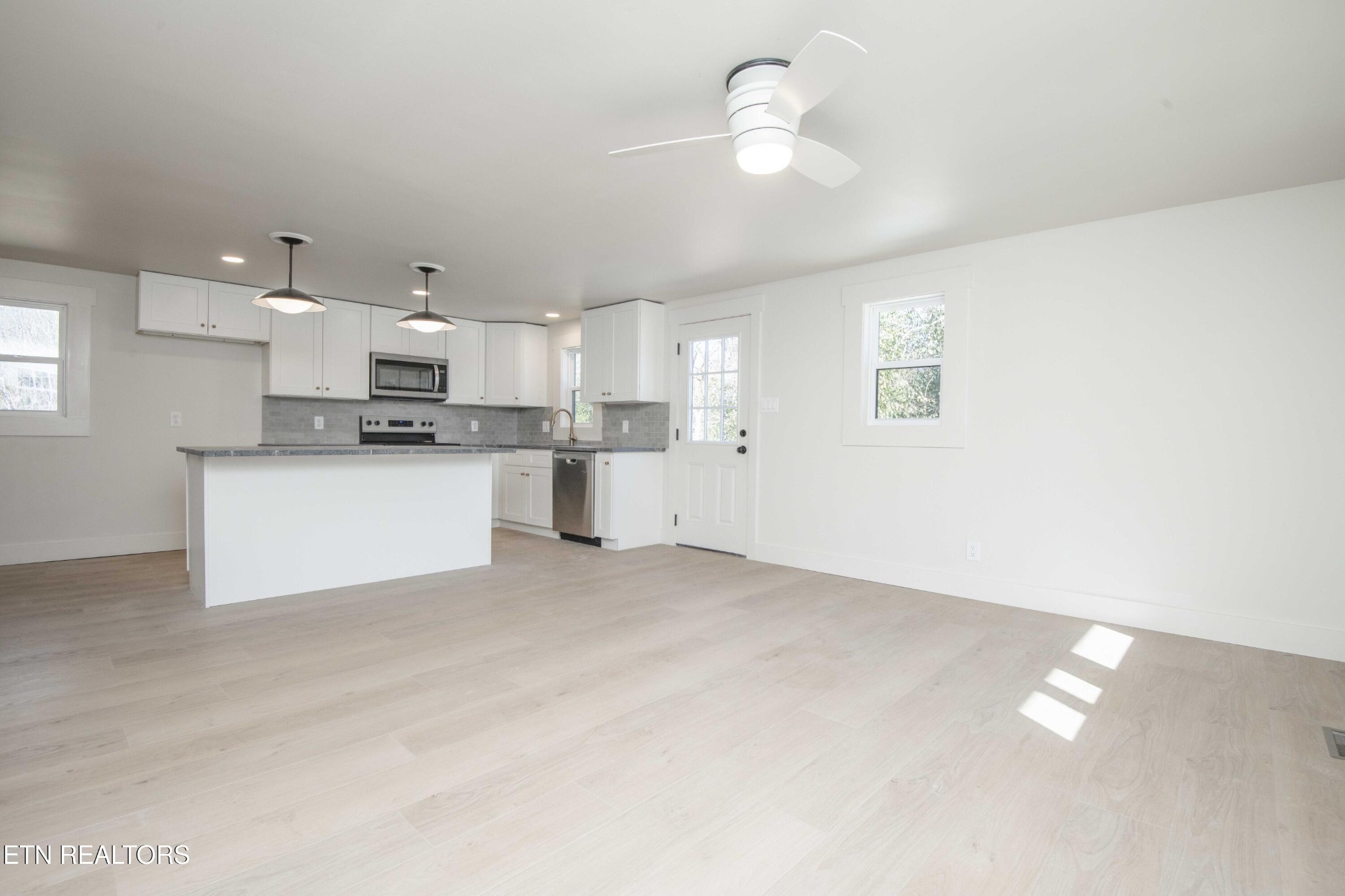 6223 Babelay Road Knoxville, TN 37924 - Photo 15 of 53 a view of a kitchen with a sink a refrigerator and a chandelier