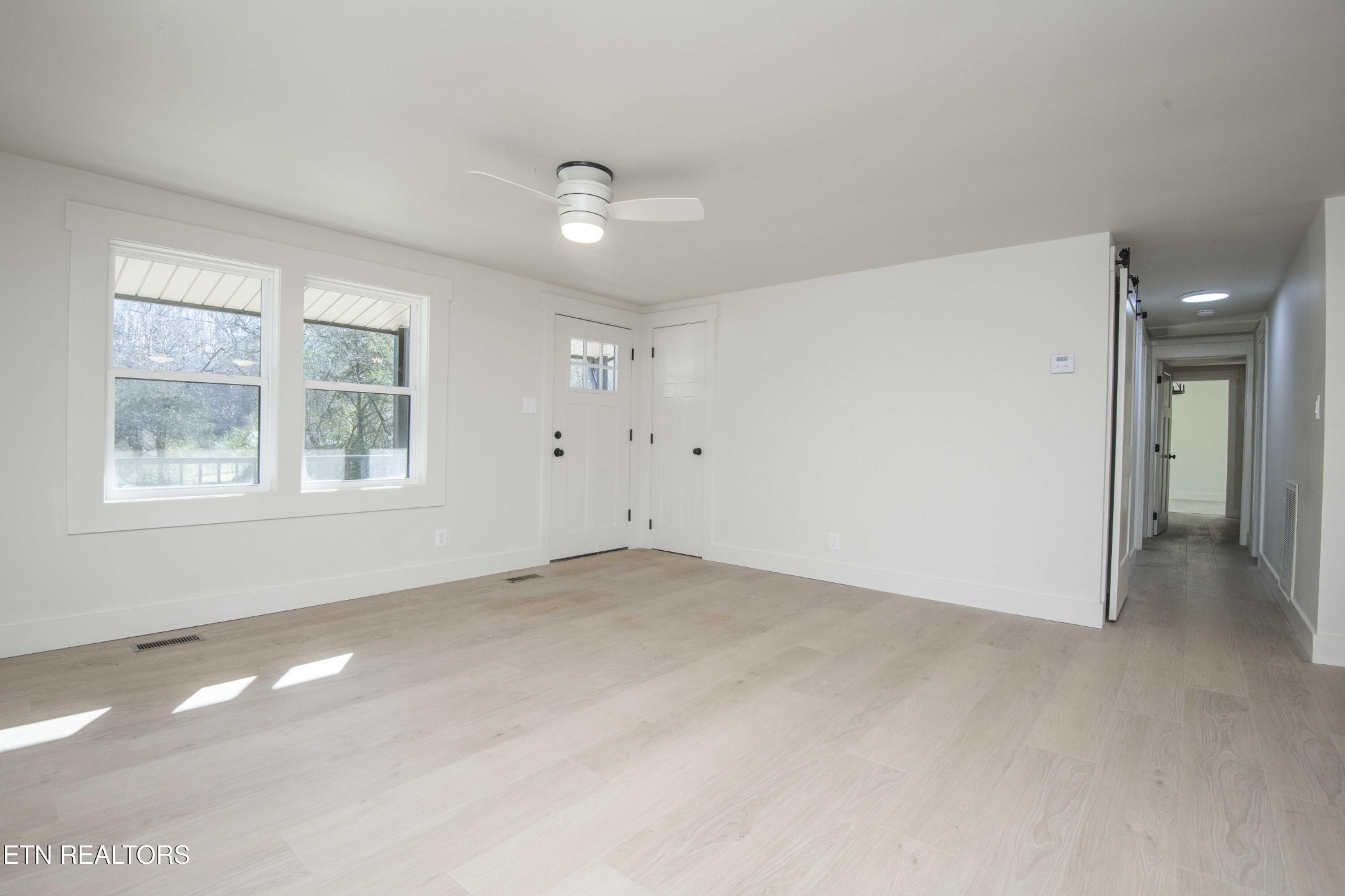 6223 Babelay Road Knoxville, TN 37924 - Photo 19 of 53 wooden floor in an empty room with a window