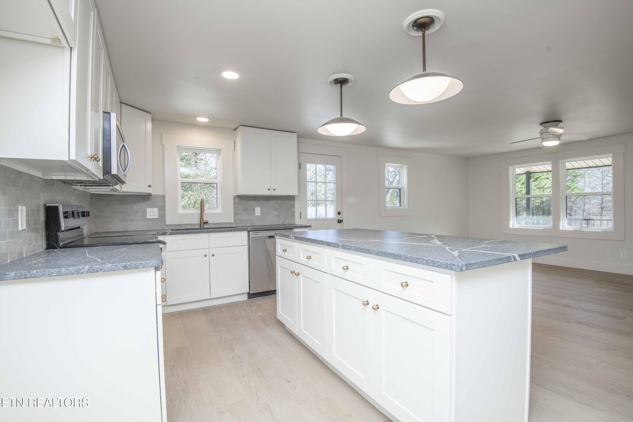 6223 Babelay Road Knoxville, TN 37924 - Photo 22 of 53 a kitchen with granite countertop white cabinets and white appliances