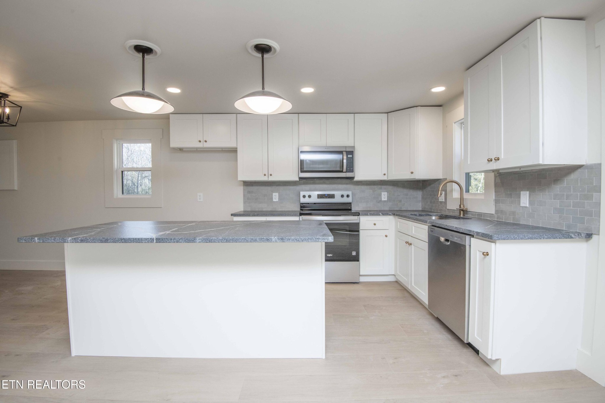 6223 Babelay Road Knoxville, TN 37924 - Photo 25 of 53 a kitchen with kitchen island granite countertop a sink a counter space stainless steel appliances and cabinets