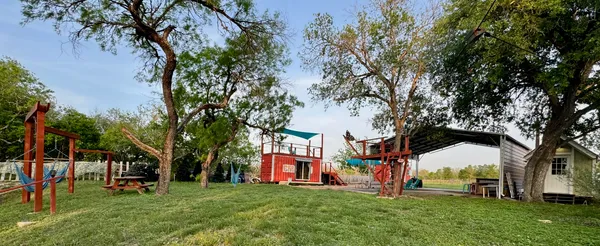 a view of a park with large trees