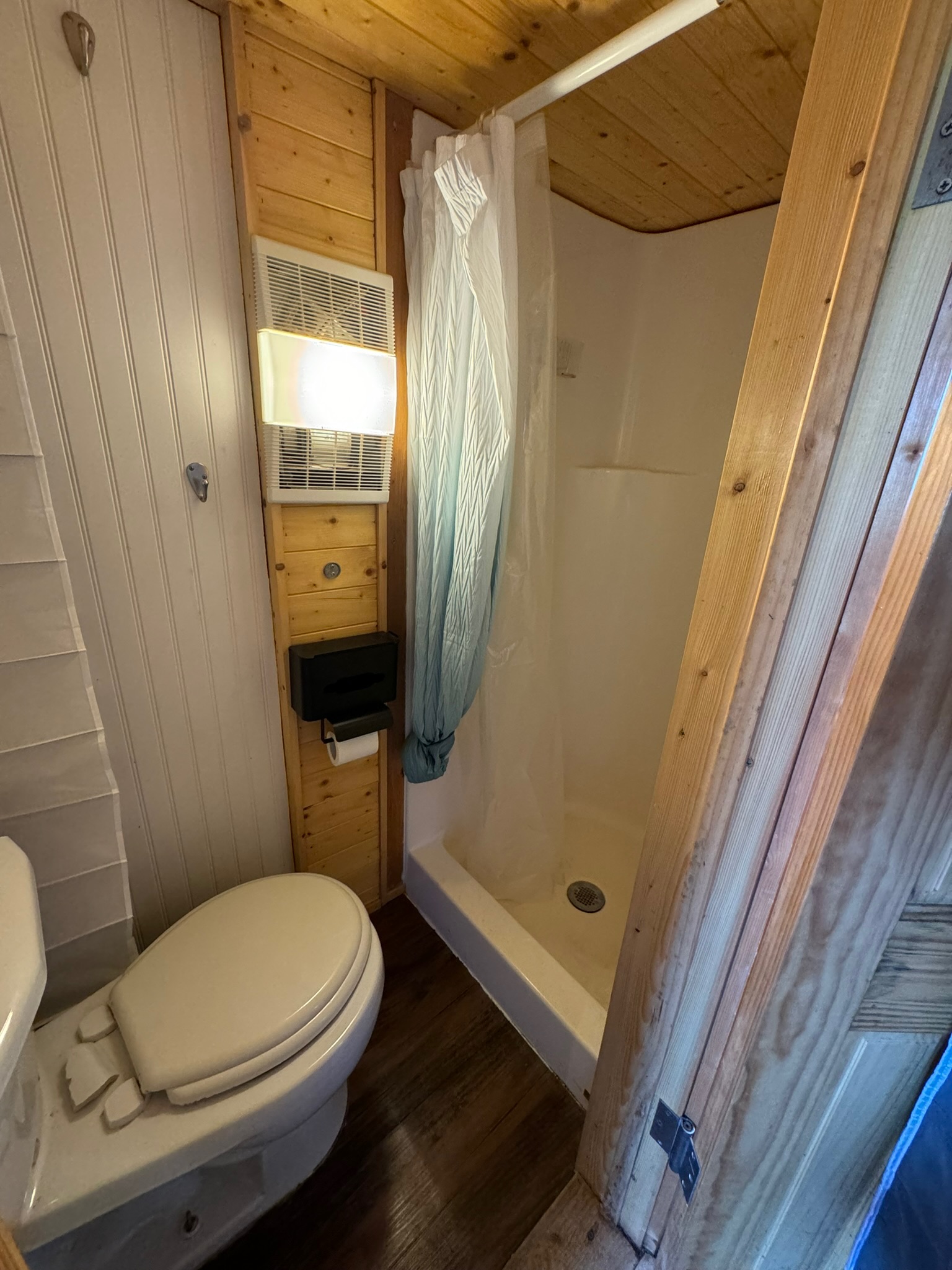 1512 River Grove Road, Unit A Kingsbury, TX 78638 - Photo 23 of 35 Bathroom featuring a shower stall, wood ceiling, dark wood-style floors, and wood walls