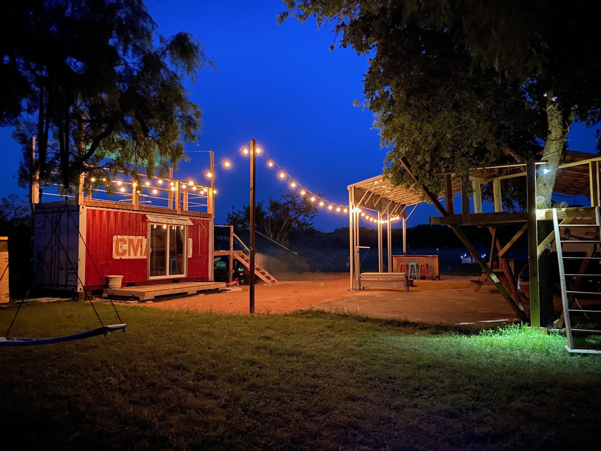 1512 River Grove Road, Unit A Kingsbury, TX 78638 - Photo 4 of 35 Playground at night with a pergola, a lawn, a deck, and a patio