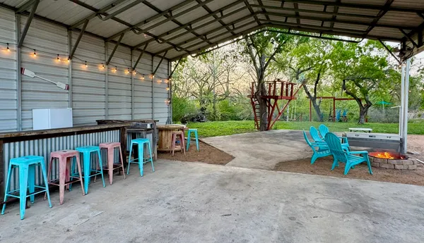 a view of a backyard with a chair and a fire pit
