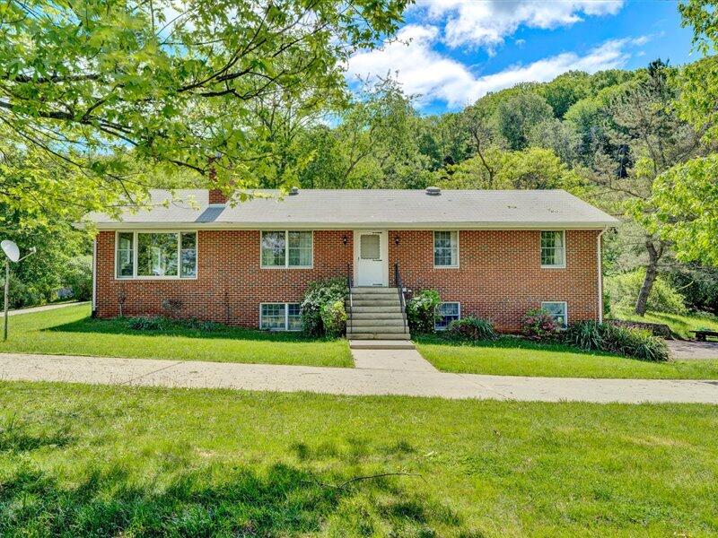 249 Zimmerman Road Blue Ridge, VA 24064 - Photo 1 of 33 a front view of a house with garden
