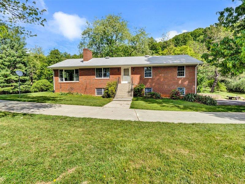 249 Zimmerman Road Blue Ridge, VA 24064 - Photo 2 of 33 a front view of a house with a yard