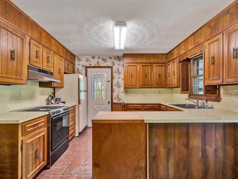249 Zimmerman Road Blue Ridge, VA 24064 - Photo 11 of 33 a kitchen with stainless steel appliances granite countertop a sink a stove and a refrigerator