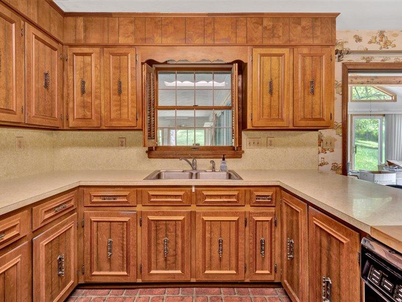 249 Zimmerman Road Blue Ridge, VA 24064 - Photo 12 of 33 a kitchen with stainless steel appliances granite countertop a sink and a cabinets