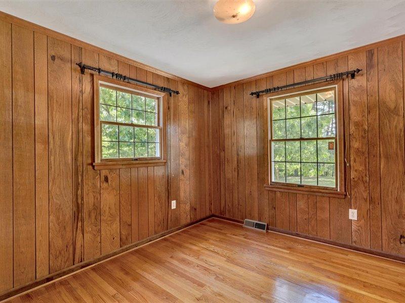 249 Zimmerman Road Blue Ridge, VA 24064 - Photo 19 of 33 an empty room with wooden floor and windows