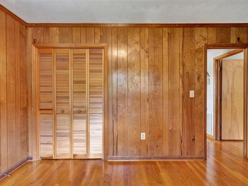 249 Zimmerman Road Blue Ridge, VA 24064 - Photo 20 of 33 an empty room with wooden floor and windows with curtains