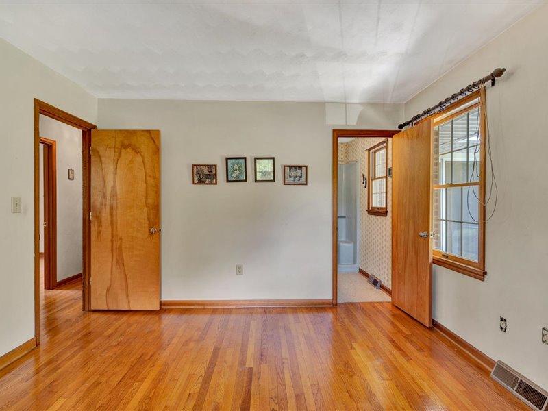 249 Zimmerman Road Blue Ridge, VA 24064 - Photo 22 of 33 a view of an empty room with wooden floor and a window