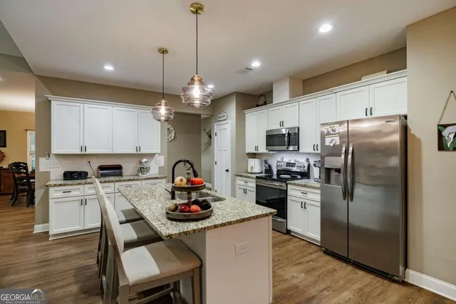 a kitchen with refrigerator a stove a sink and a refrigerator