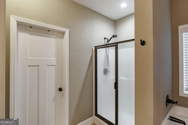 a bathroom with a bathtub and a window