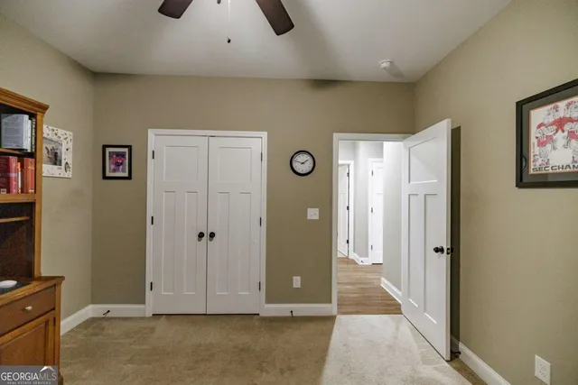 a bedroom with a bed and a ceiling fan