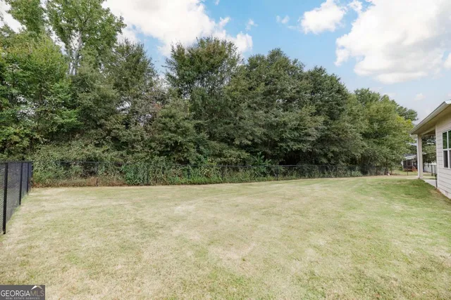 a view of house with yard and green space