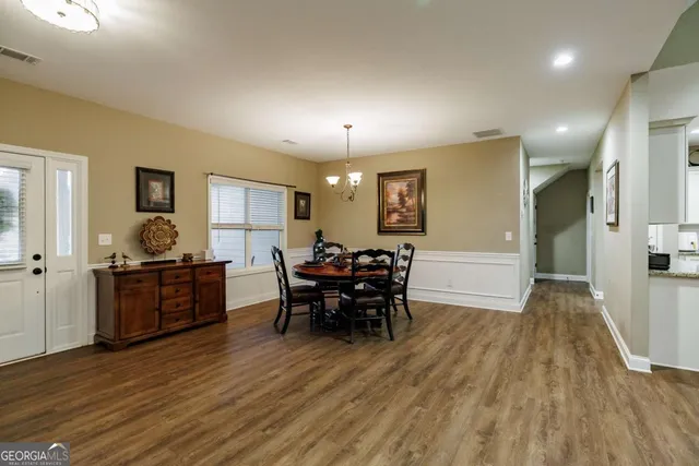 a view of a dining room with furniture window and wooden floor