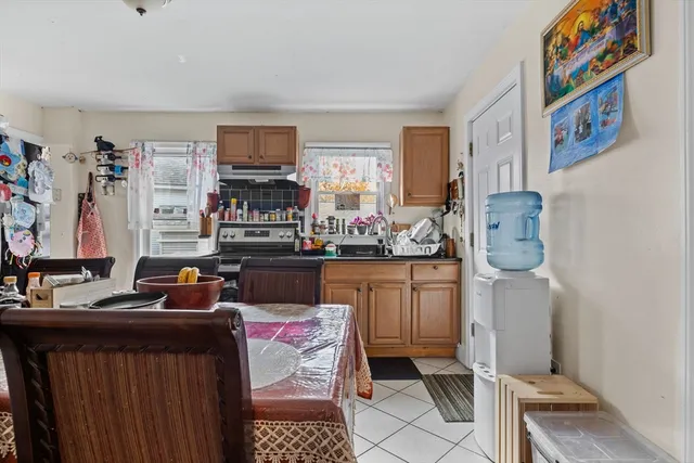 a room with furniture a flat screen tv and a window