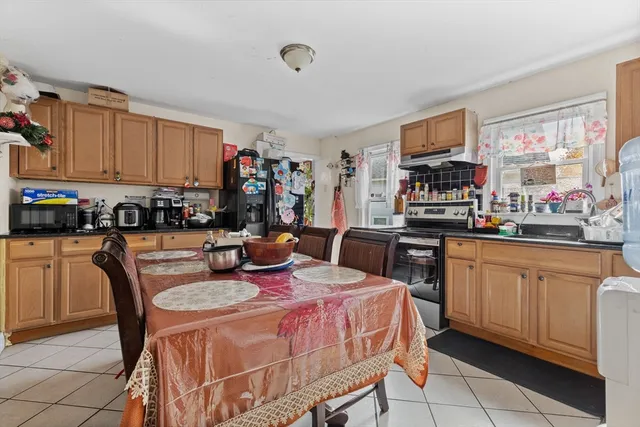 a kitchen with granite countertop a sink counter top space and stainless steel appliances