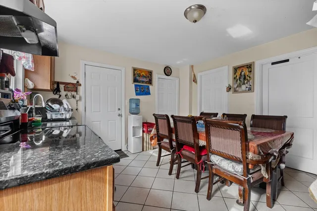 a view of a dining room with furniture and a kitchen